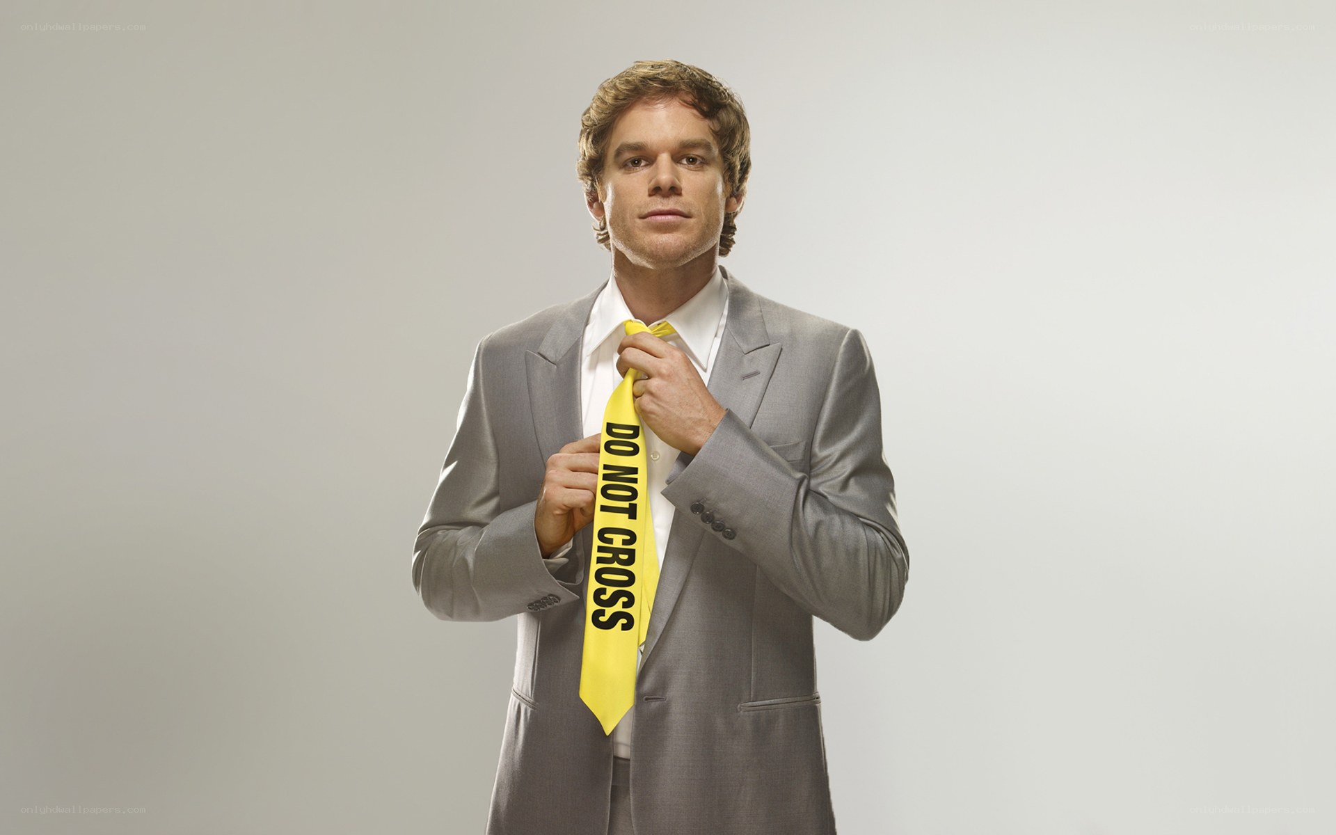 Man in suit with caution tape tie