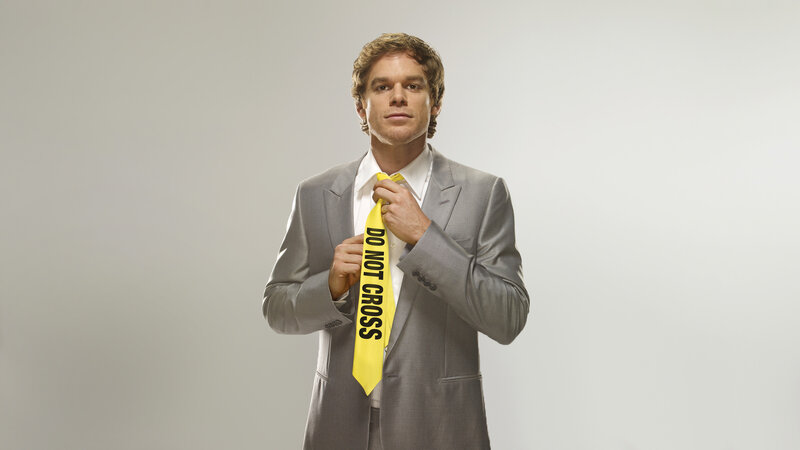 Man in suit with caution tape tie