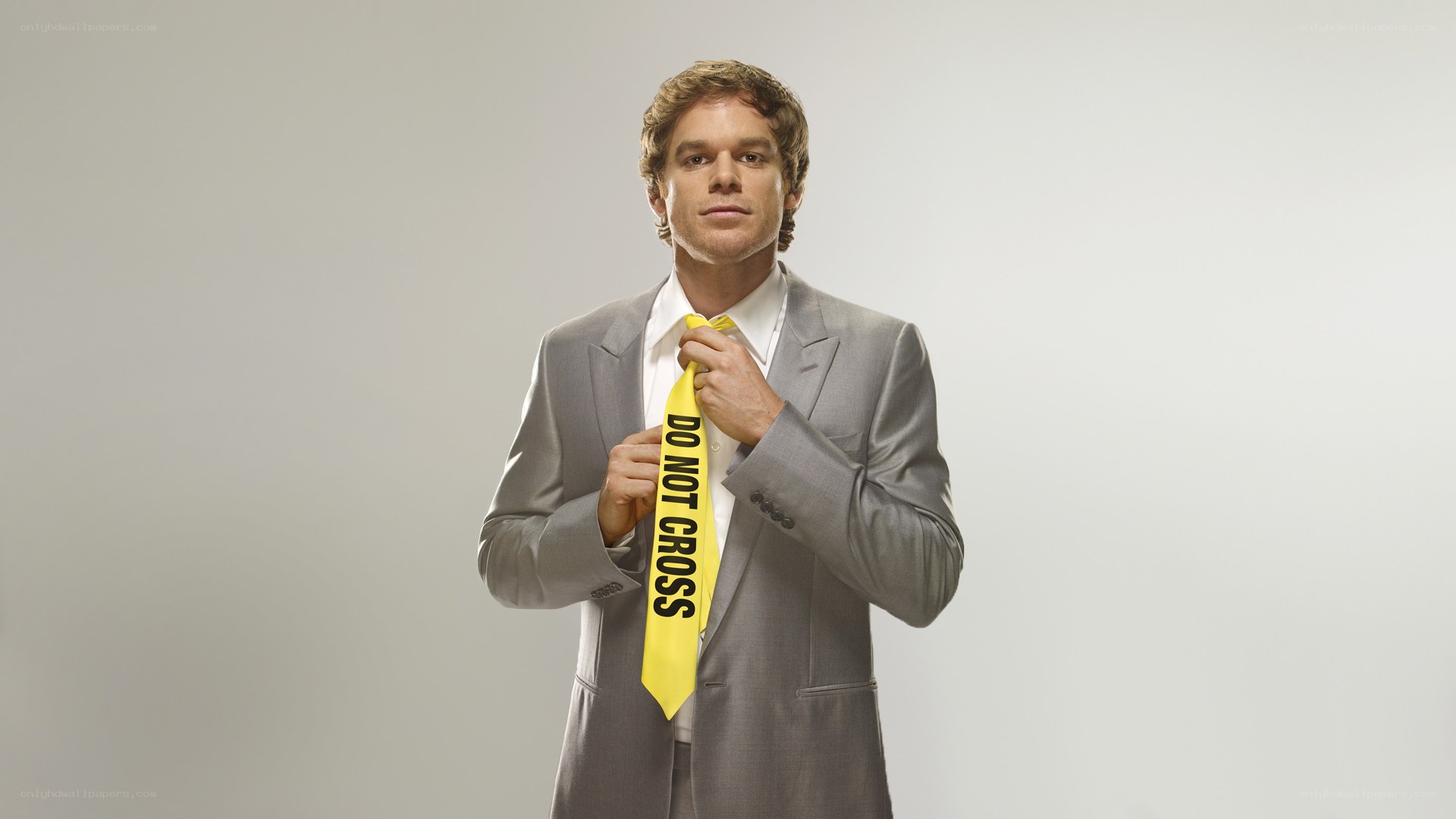 Man in suit with caution tape tie