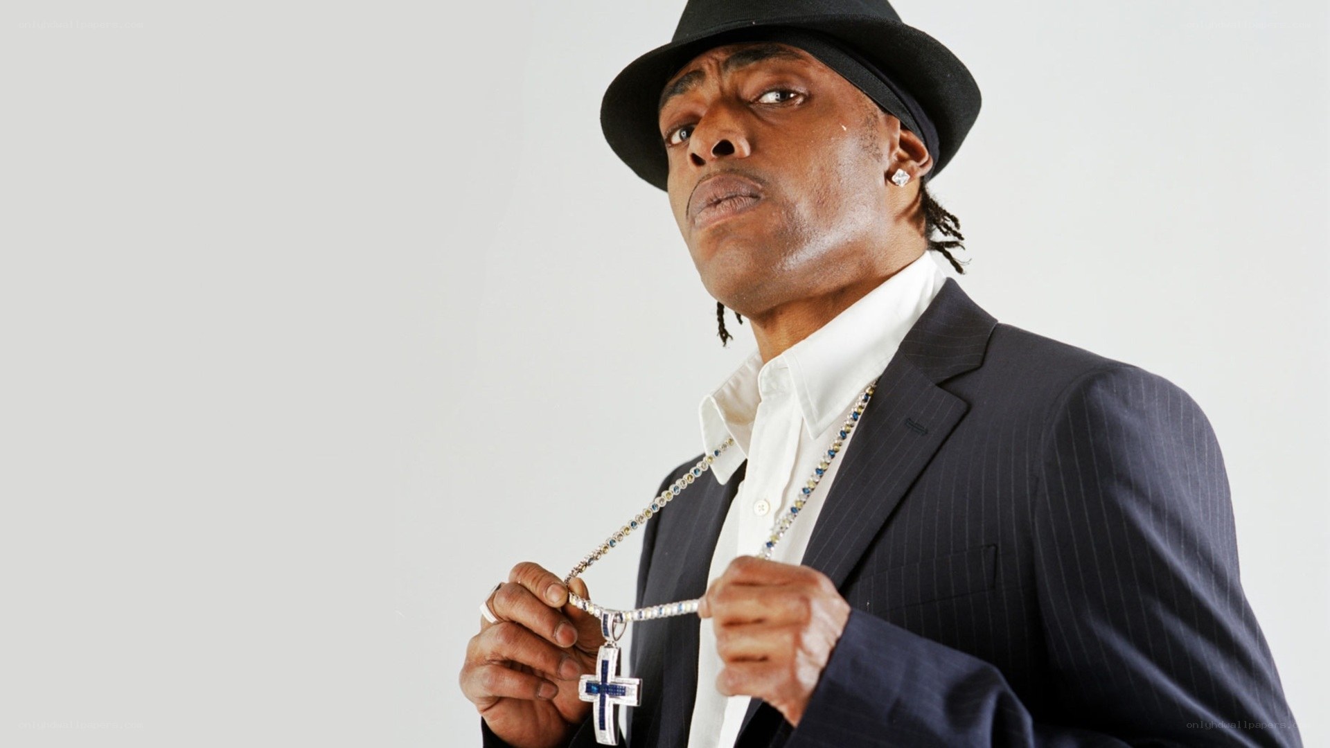 Man in suit with cross necklace