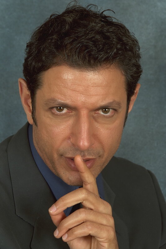 man in suit with finger to lips