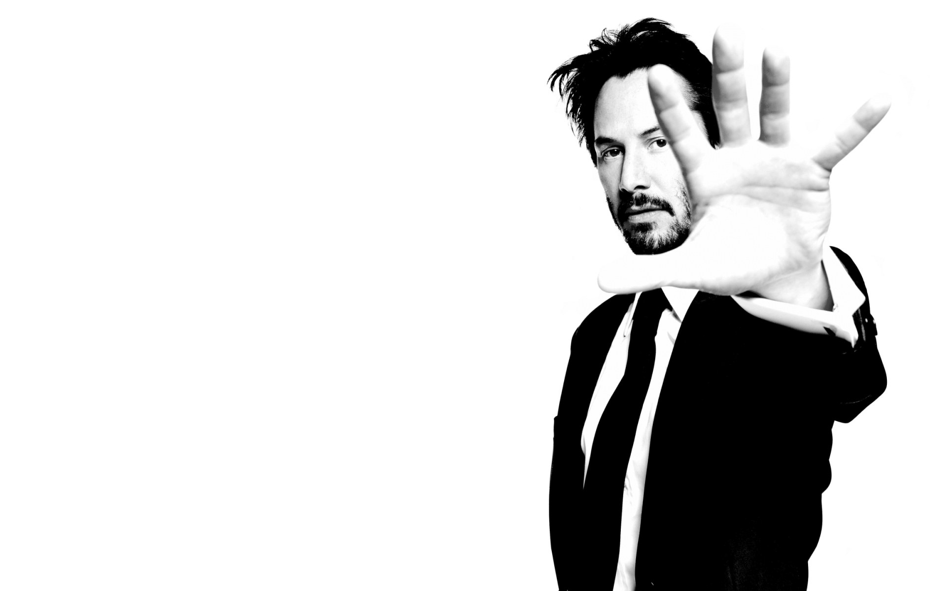 man in suit with hand gesture
