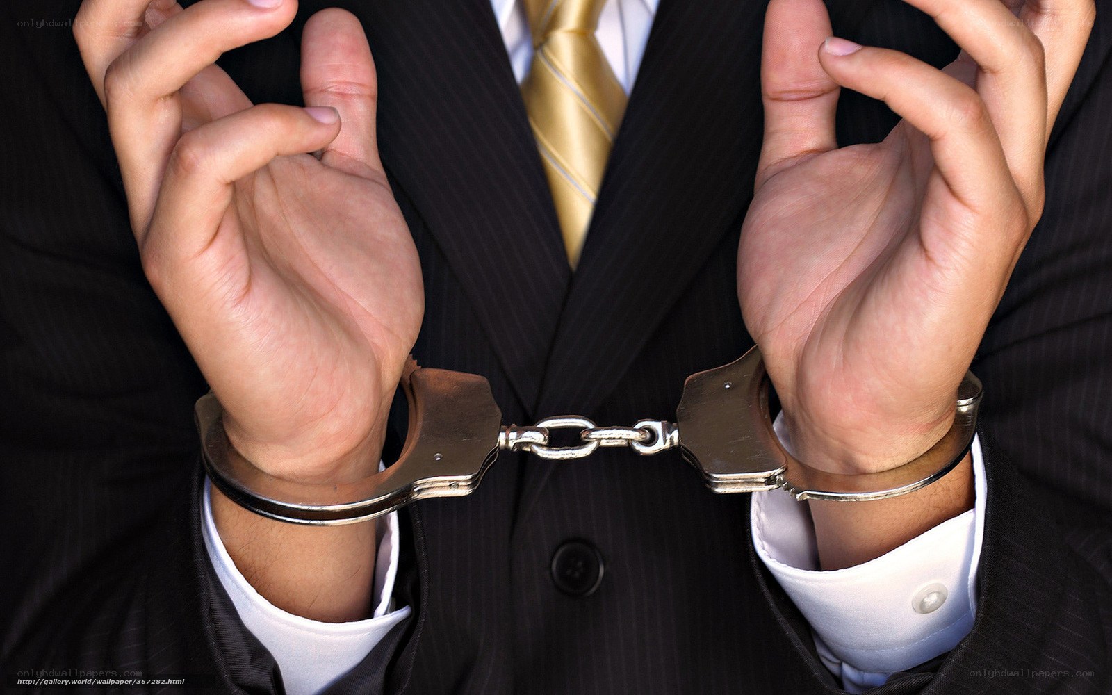 Man in suit with handcuffs