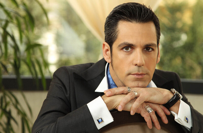 Man in Suit with Hands Clasped — Black, Serious