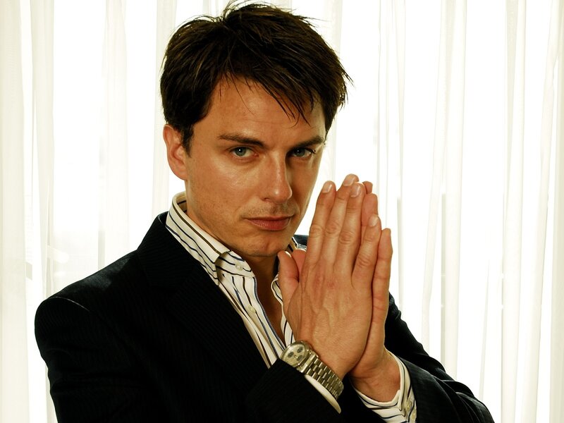 man in suit with hands clasped