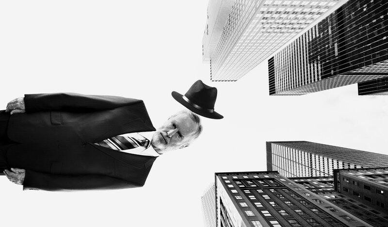 man in suit with hat floating