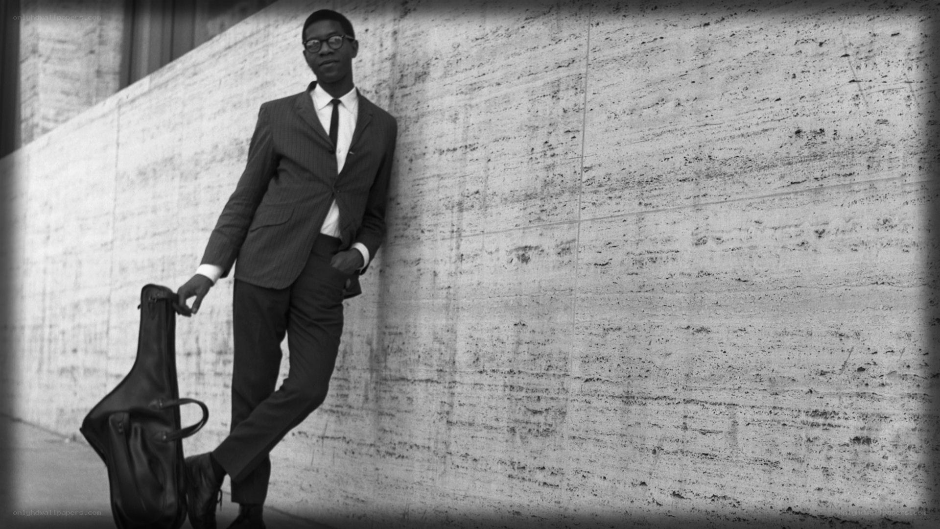 Man in suit with instrument case