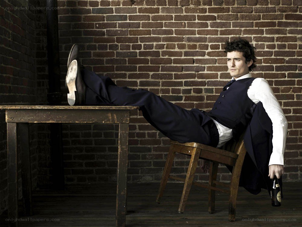 Man in suit with legs on table