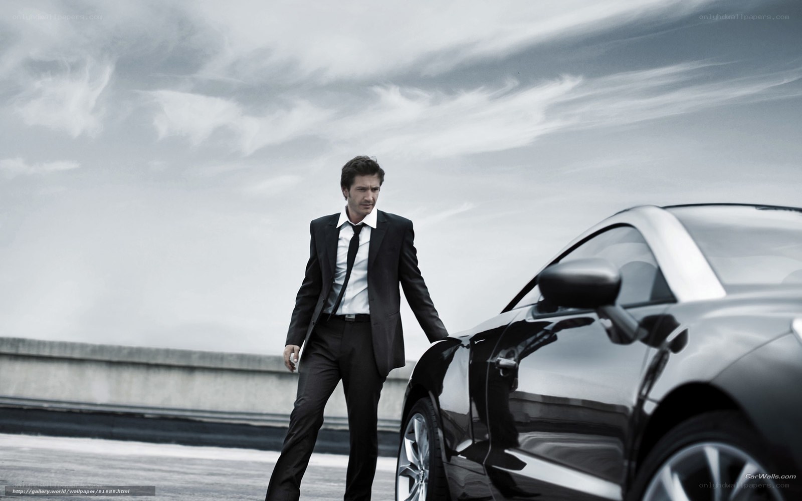 Man in suit with luxury car