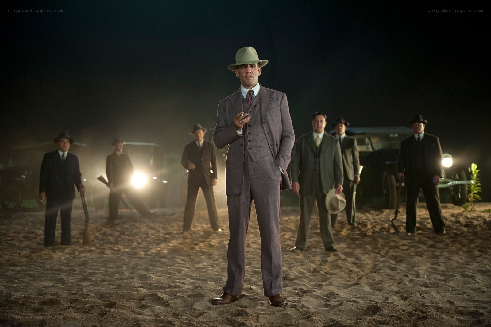 Man in suit with men behind him