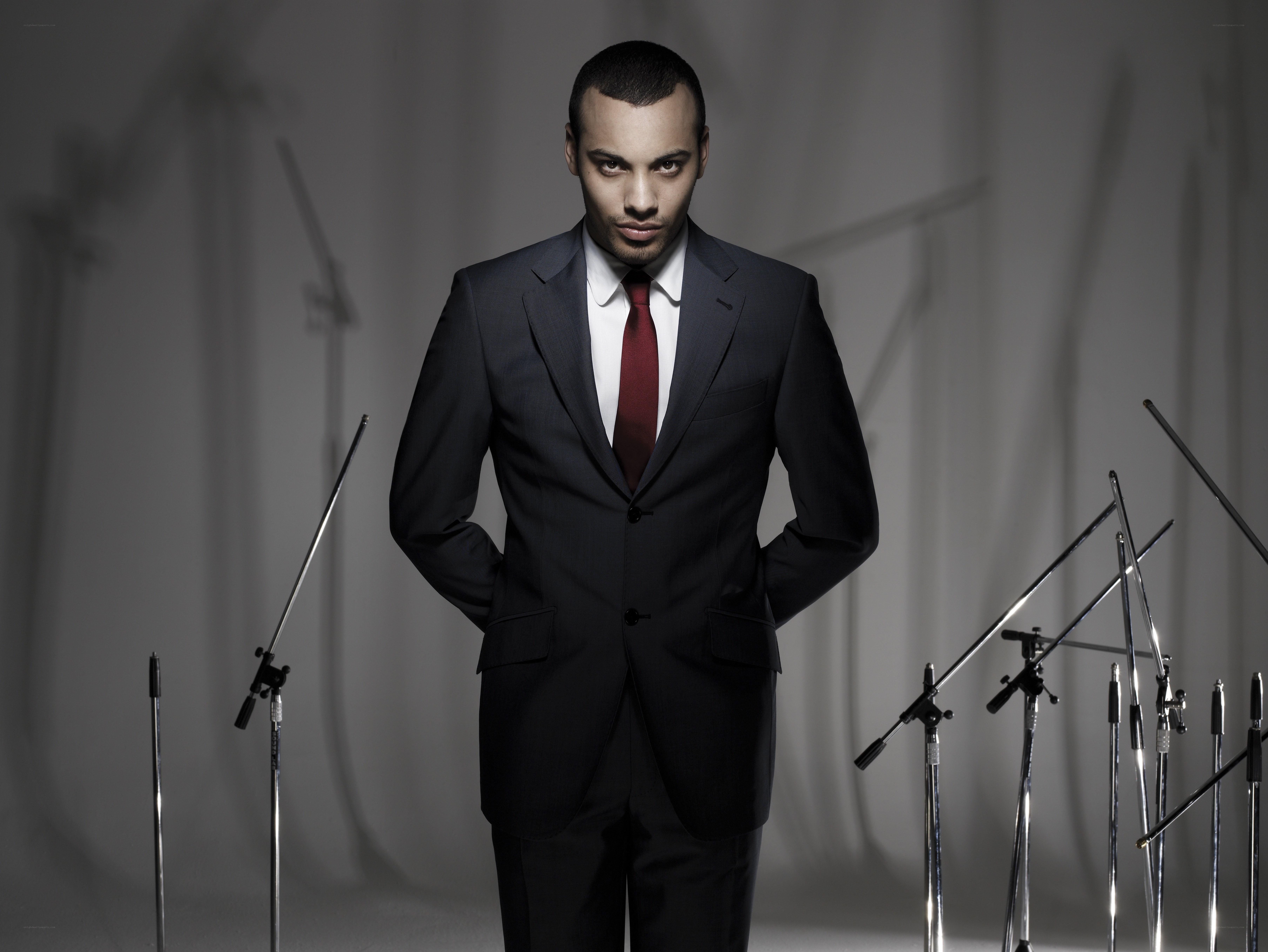 man in suit with microphones