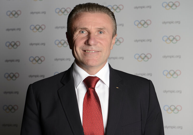 man in suit with olympic logo