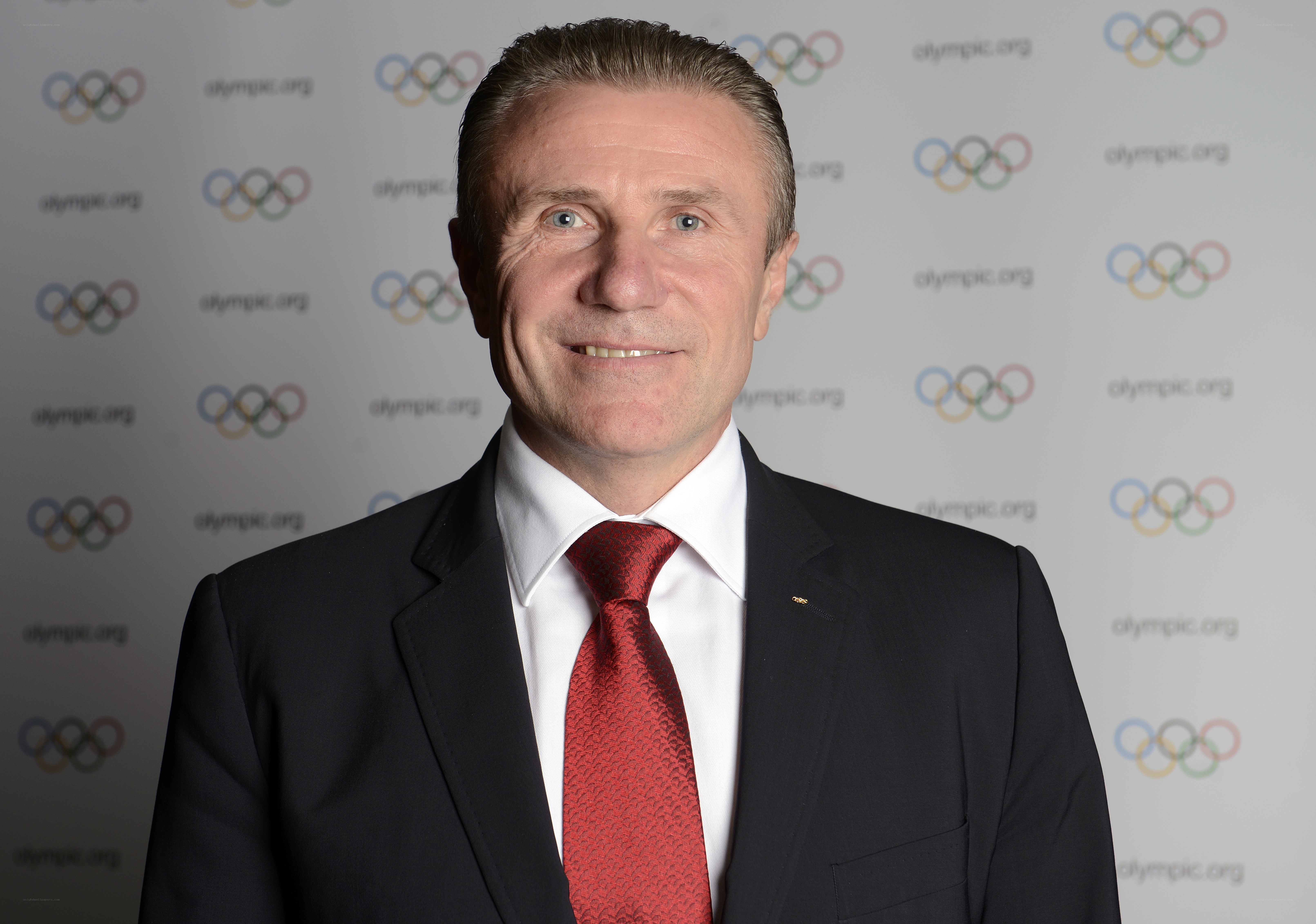 man in suit with olympic logo