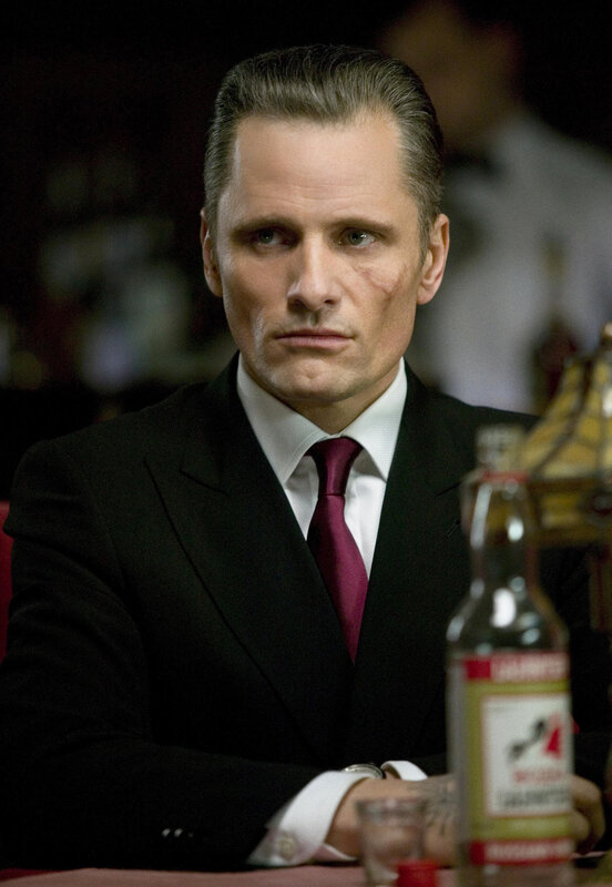 man in suit with scar
