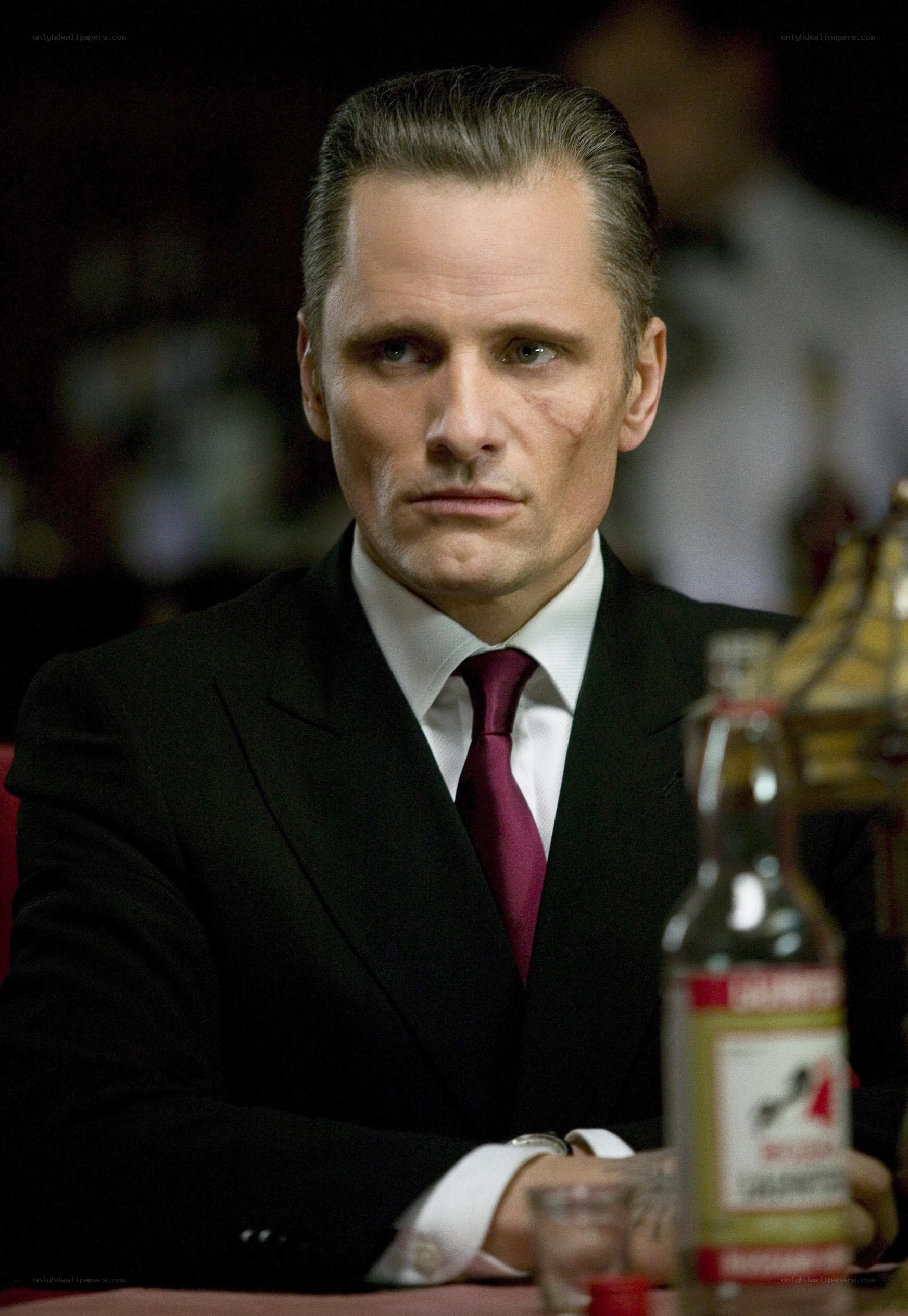 man in suit with scar