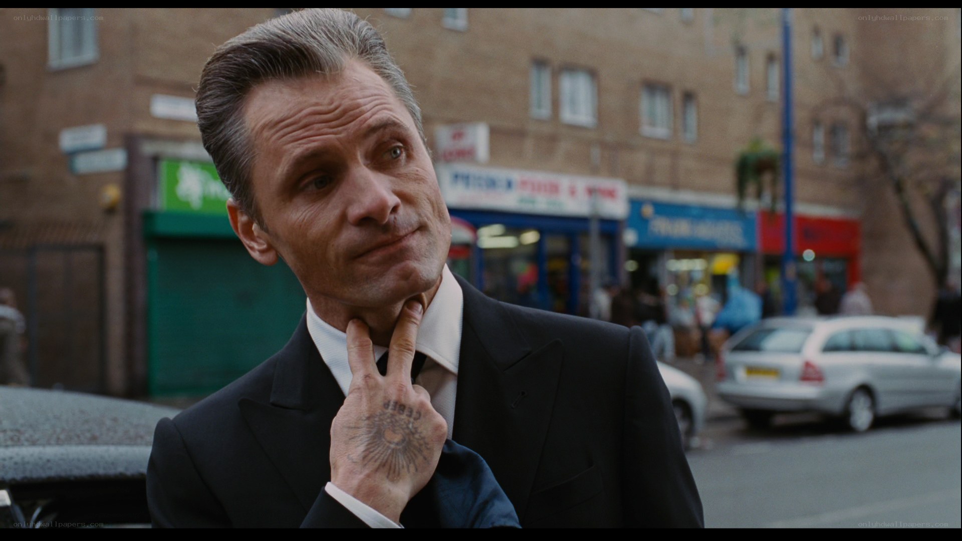 man in suit with tattoo