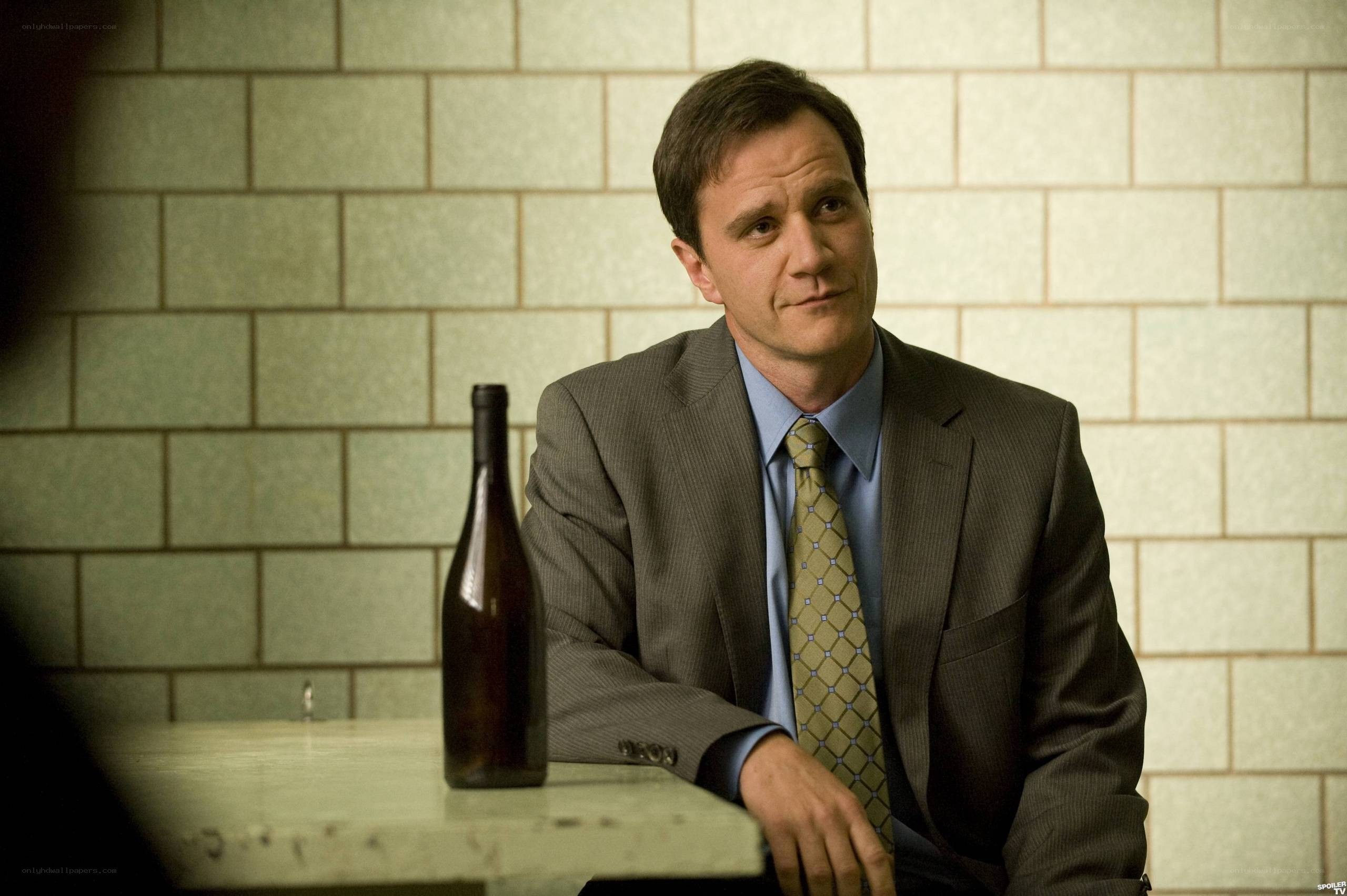 Man in suit with wine bottle