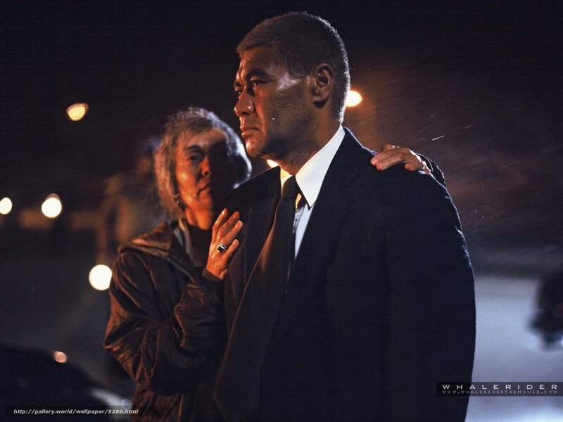 man in suit with woman behind