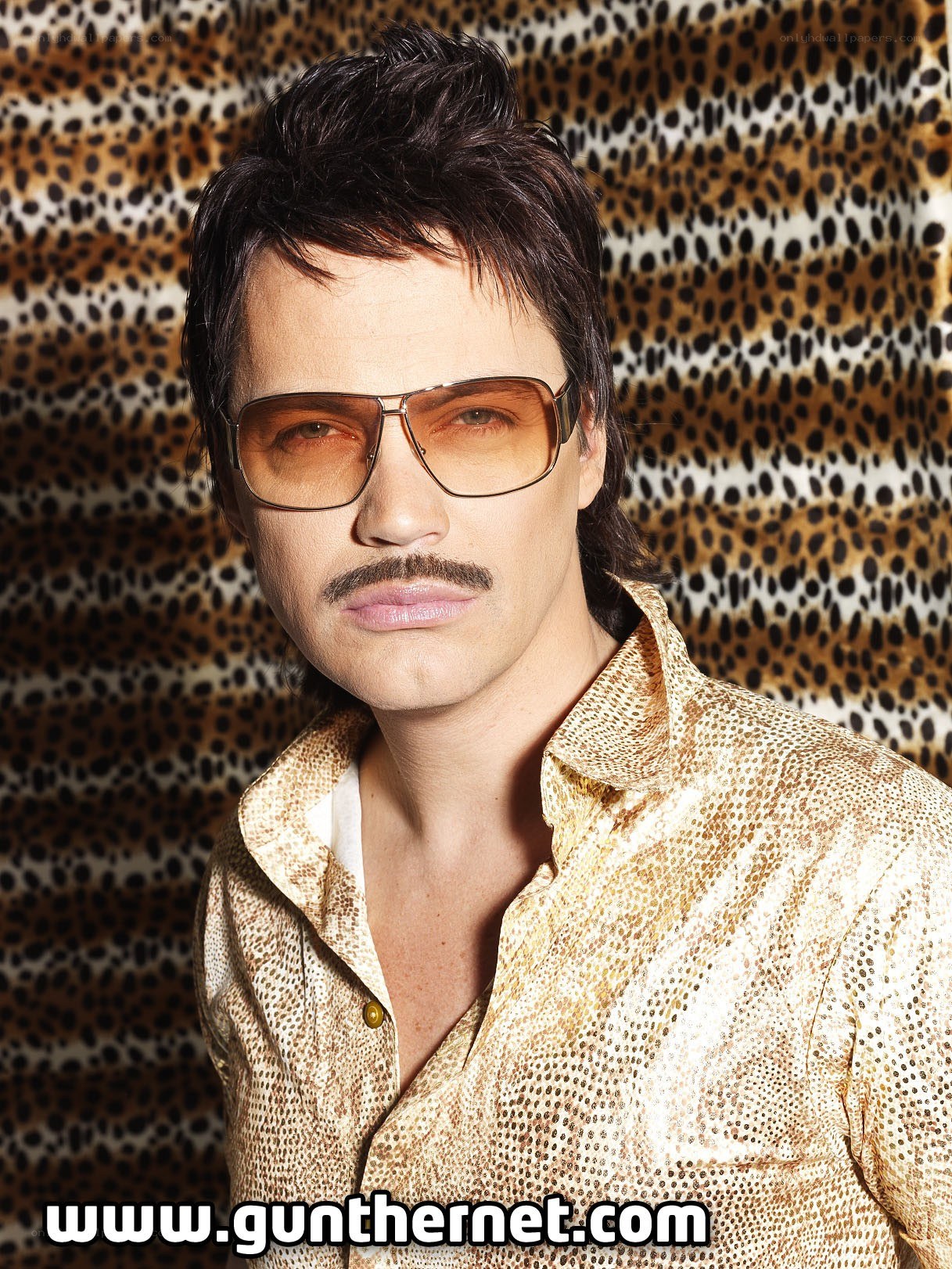 man in sunglasses and patterned shirt