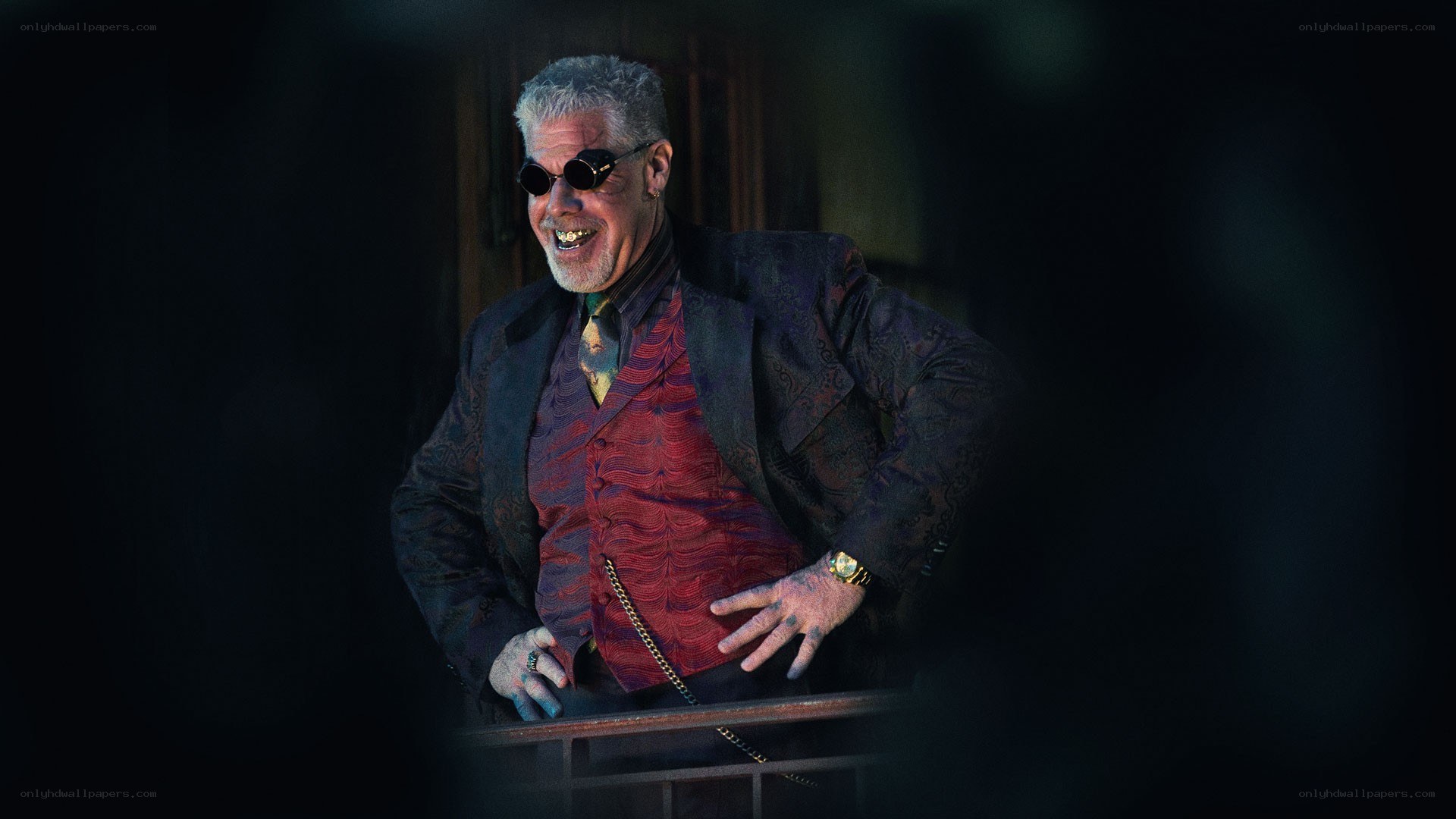 man in sunglasses and red vest