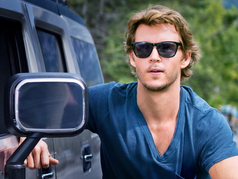 man in sunglasses by car