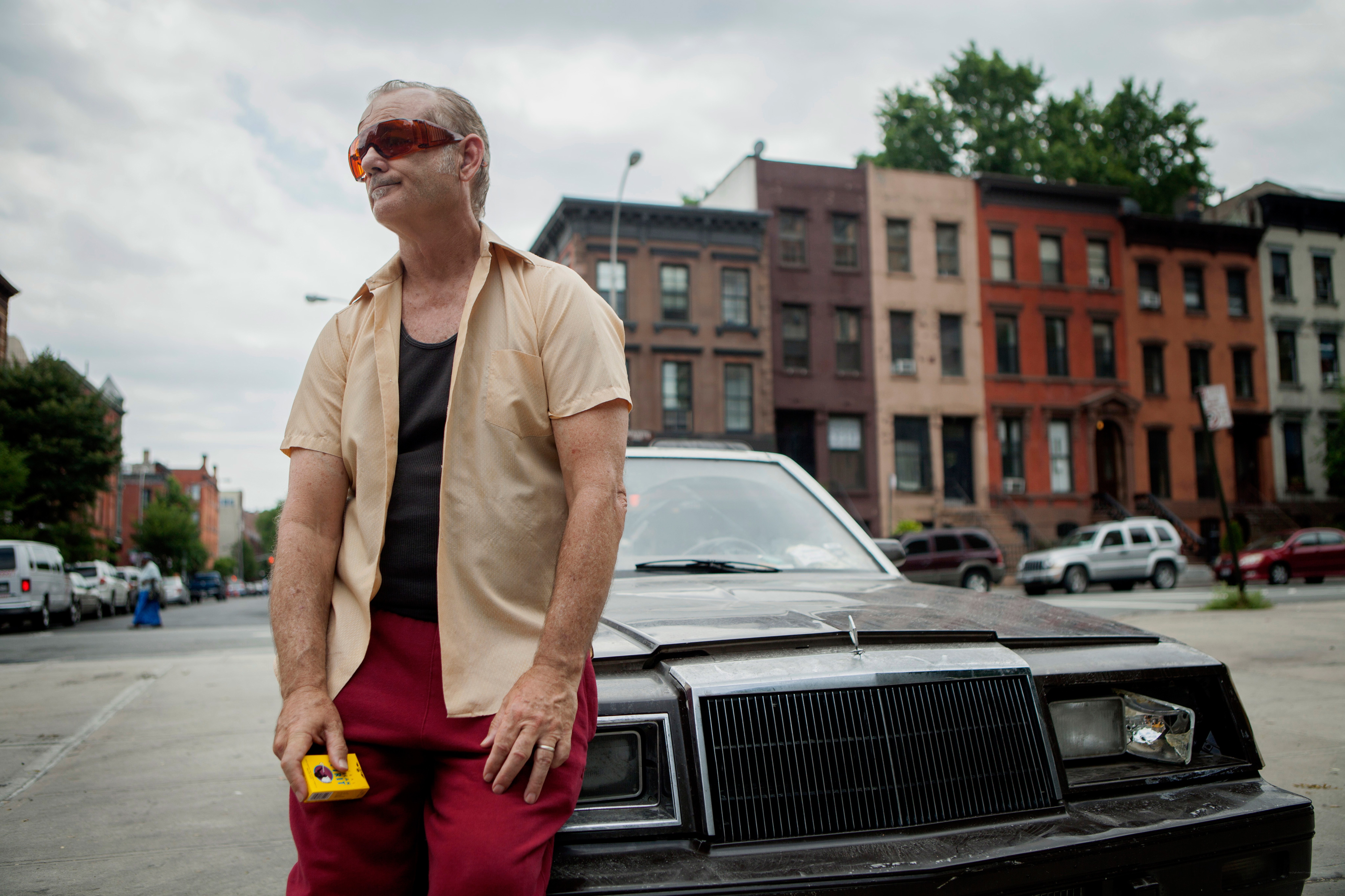 Man in sunglasses by car