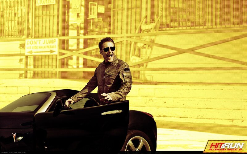 man in sunglasses by car