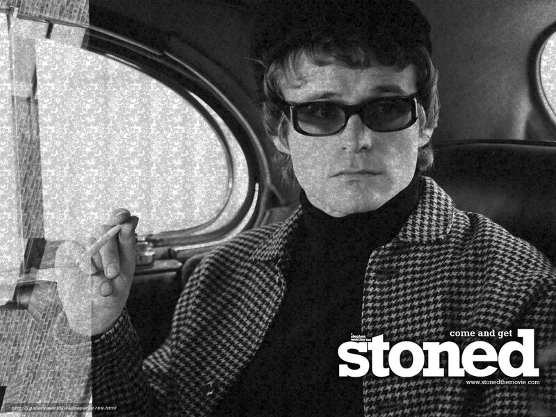 man in sunglasses holding cigarette