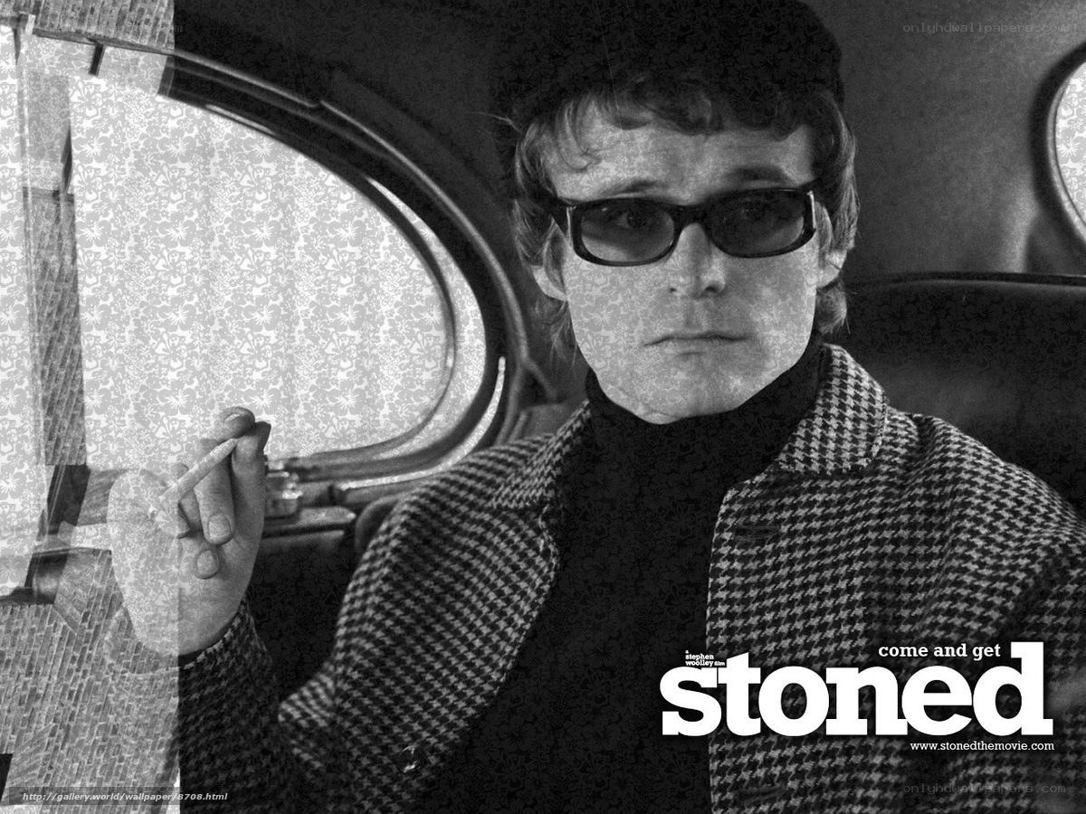 man in sunglasses holding cigarette