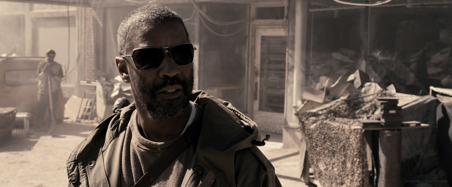 man in sunglasses in war zone