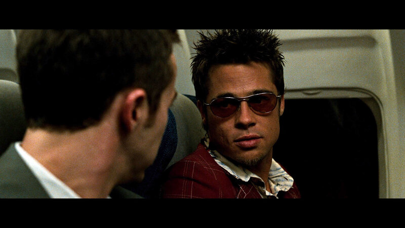 man in sunglasses on plane