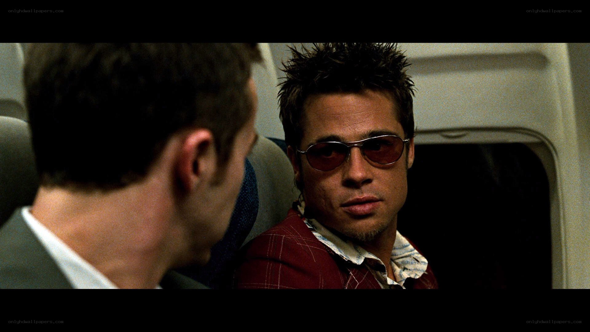 man in sunglasses on plane