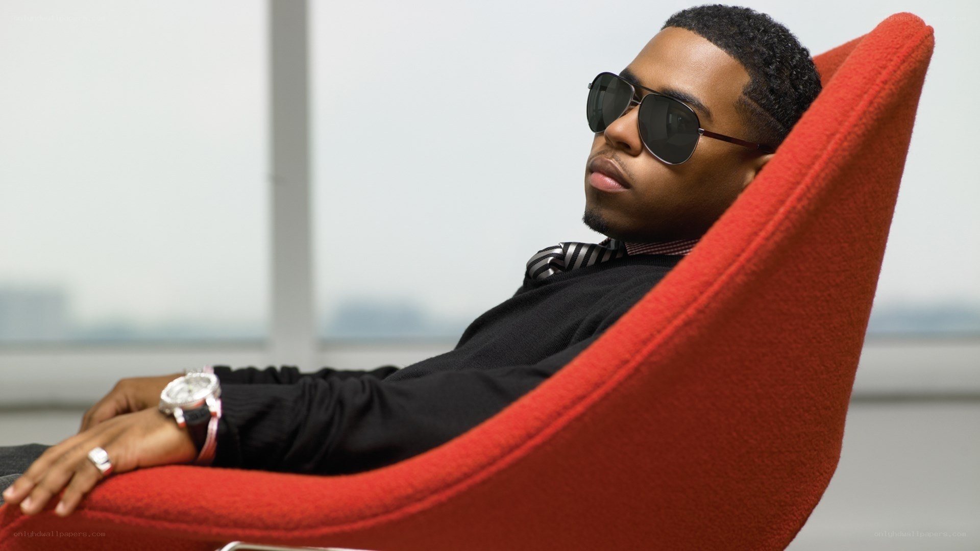 man in sunglasses on red chair