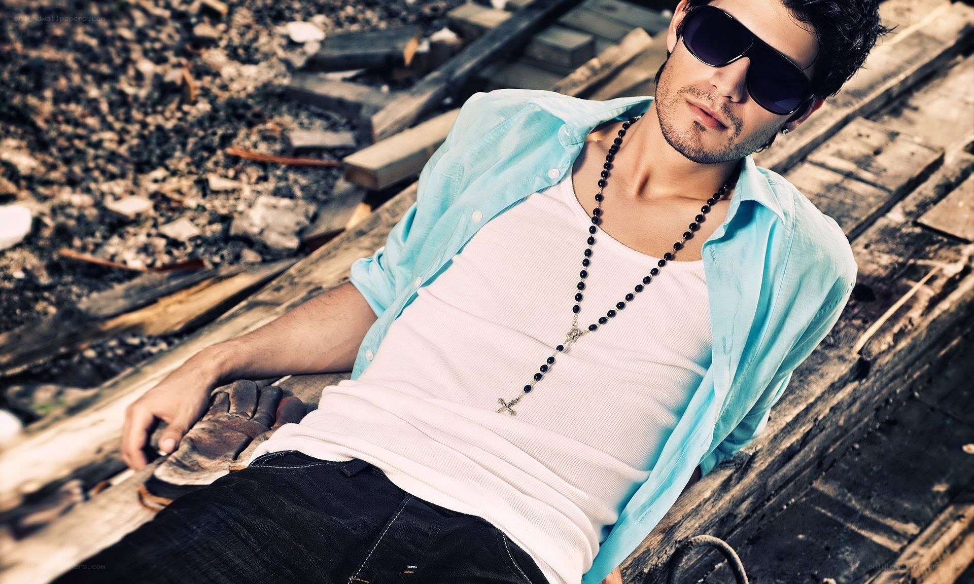 man in sunglasses on train tracks