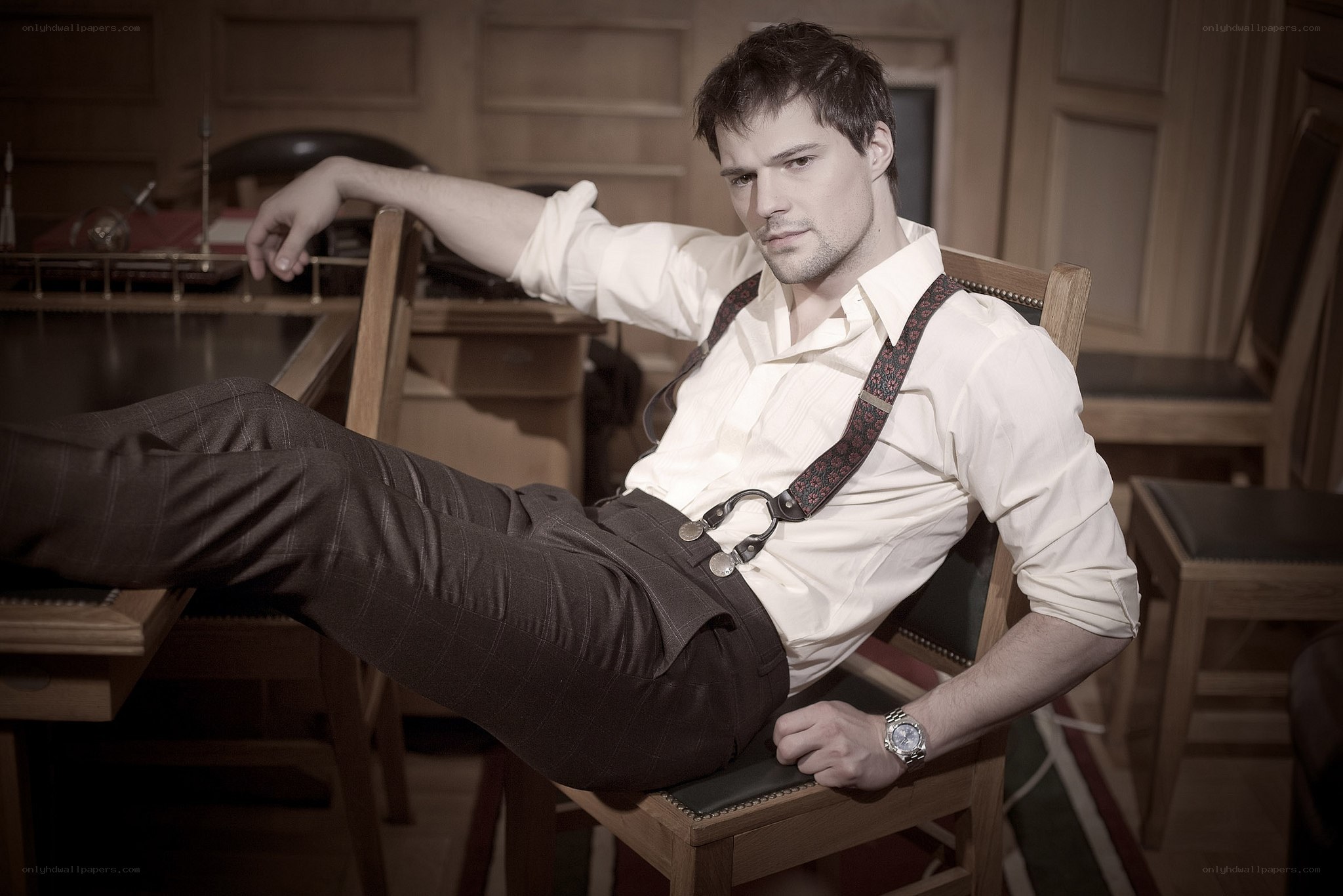 man in suspenders posing