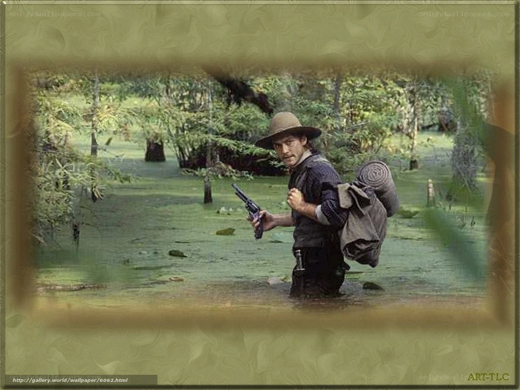 man in swamp with gun