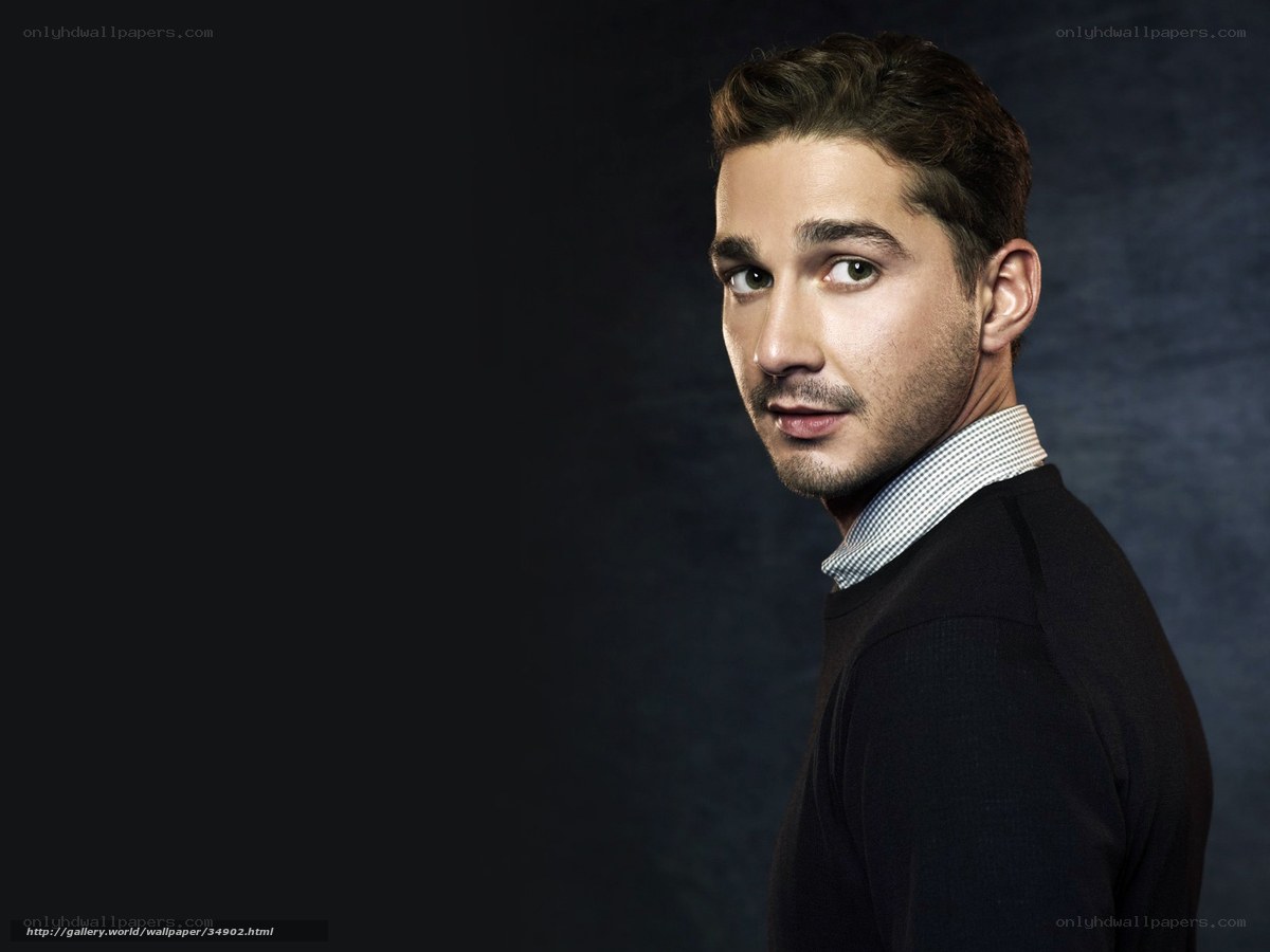 man in sweater looking over shoulder