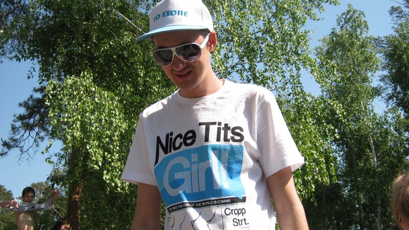 Man in t-shirt and cap outdoors