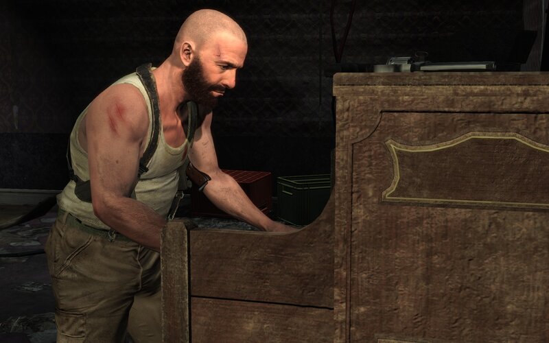 man in tank top at desk