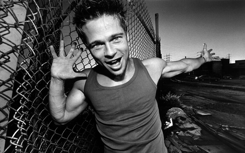 man in tank top by fence