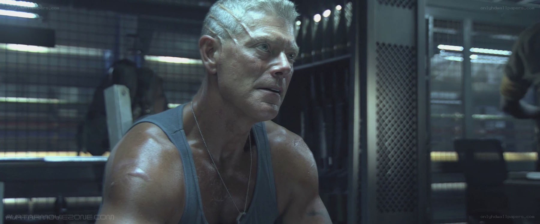 man in tank top looking serious