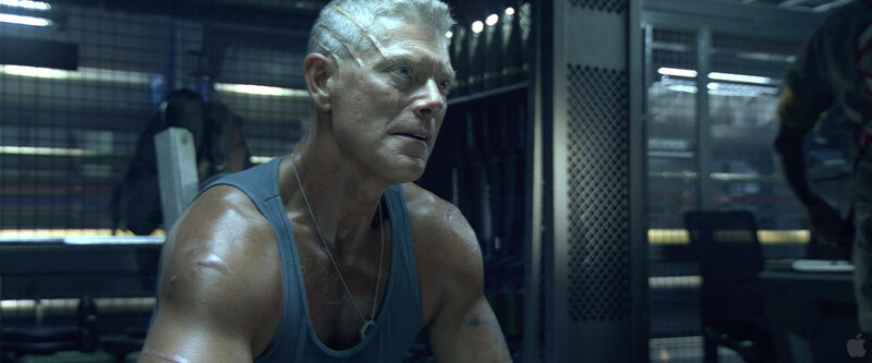 man in tank top looking serious