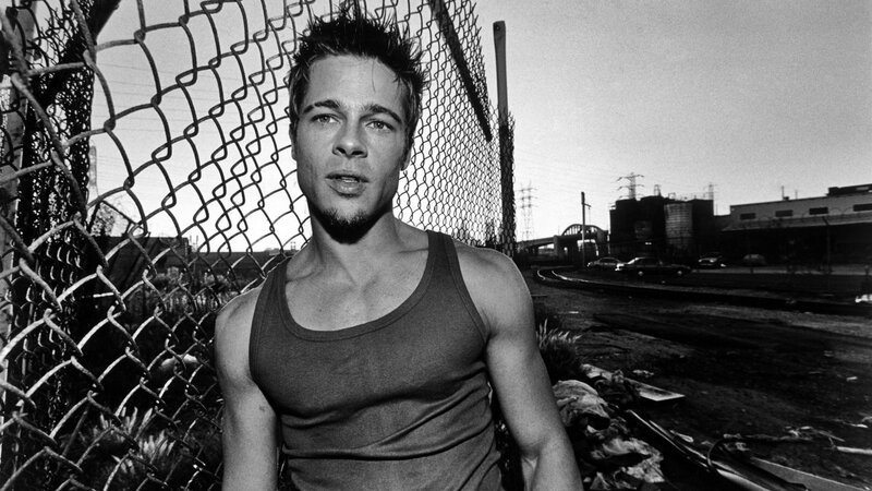 man in tank top near fence