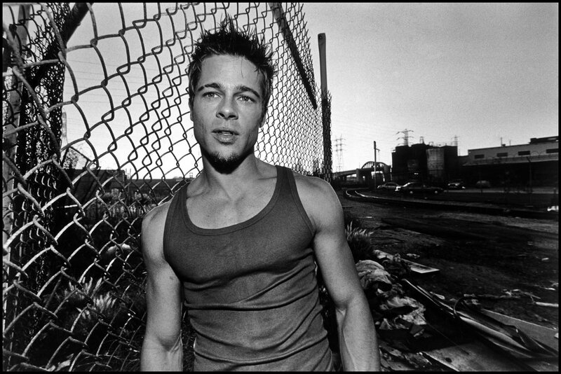 man in tank top near fence