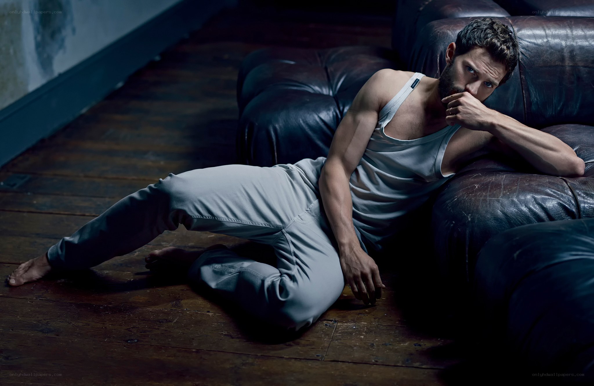 man in tank top on floor
