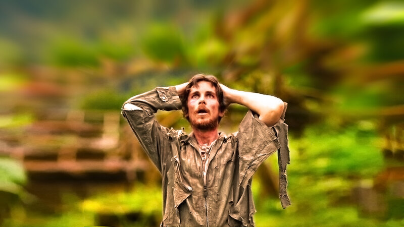 man in tattered clothes looking up