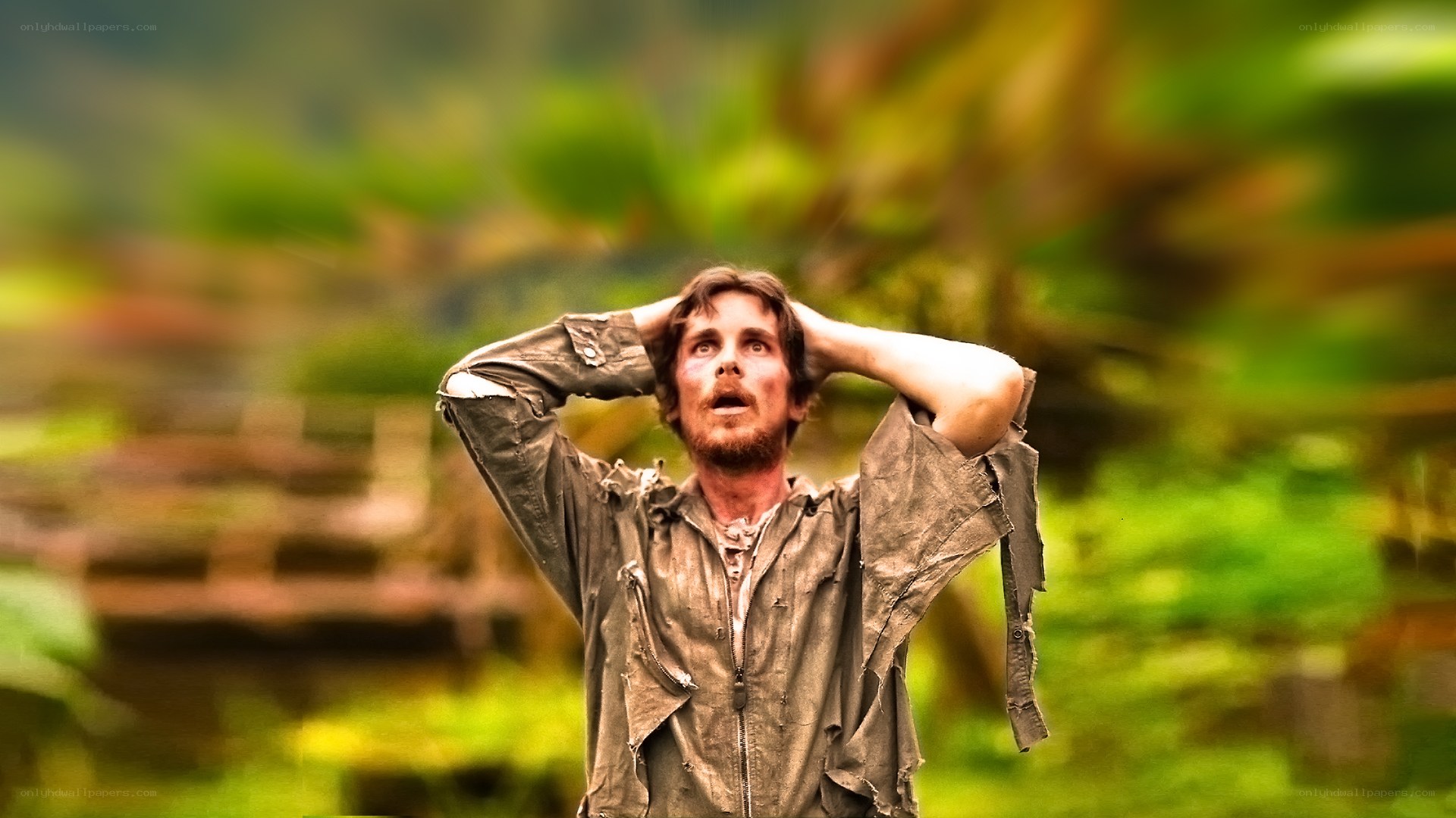 man in tattered clothes looking up