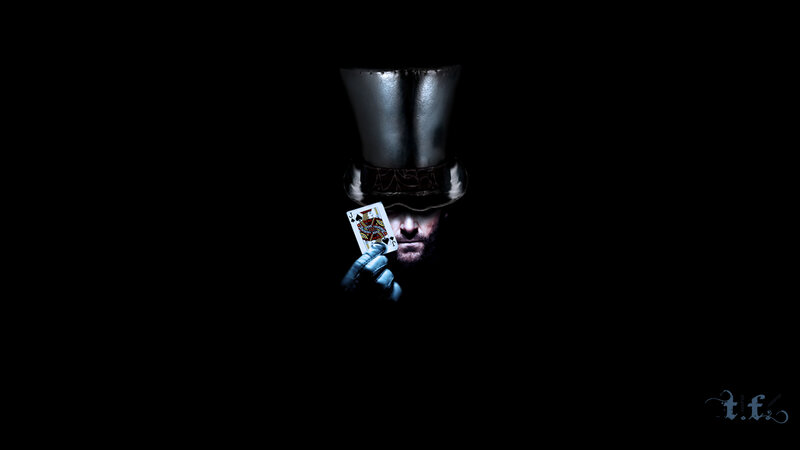 man in top hat holding card