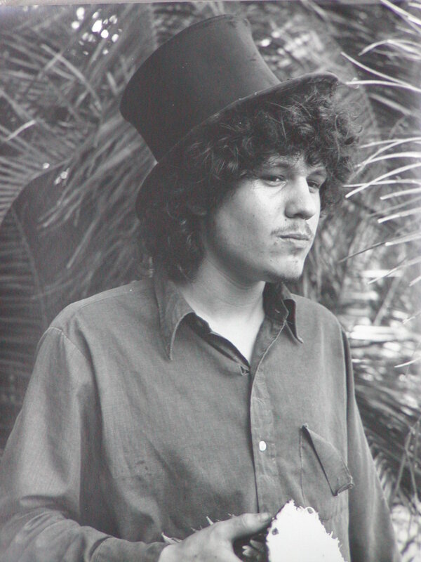 man in top hat holding coconut
