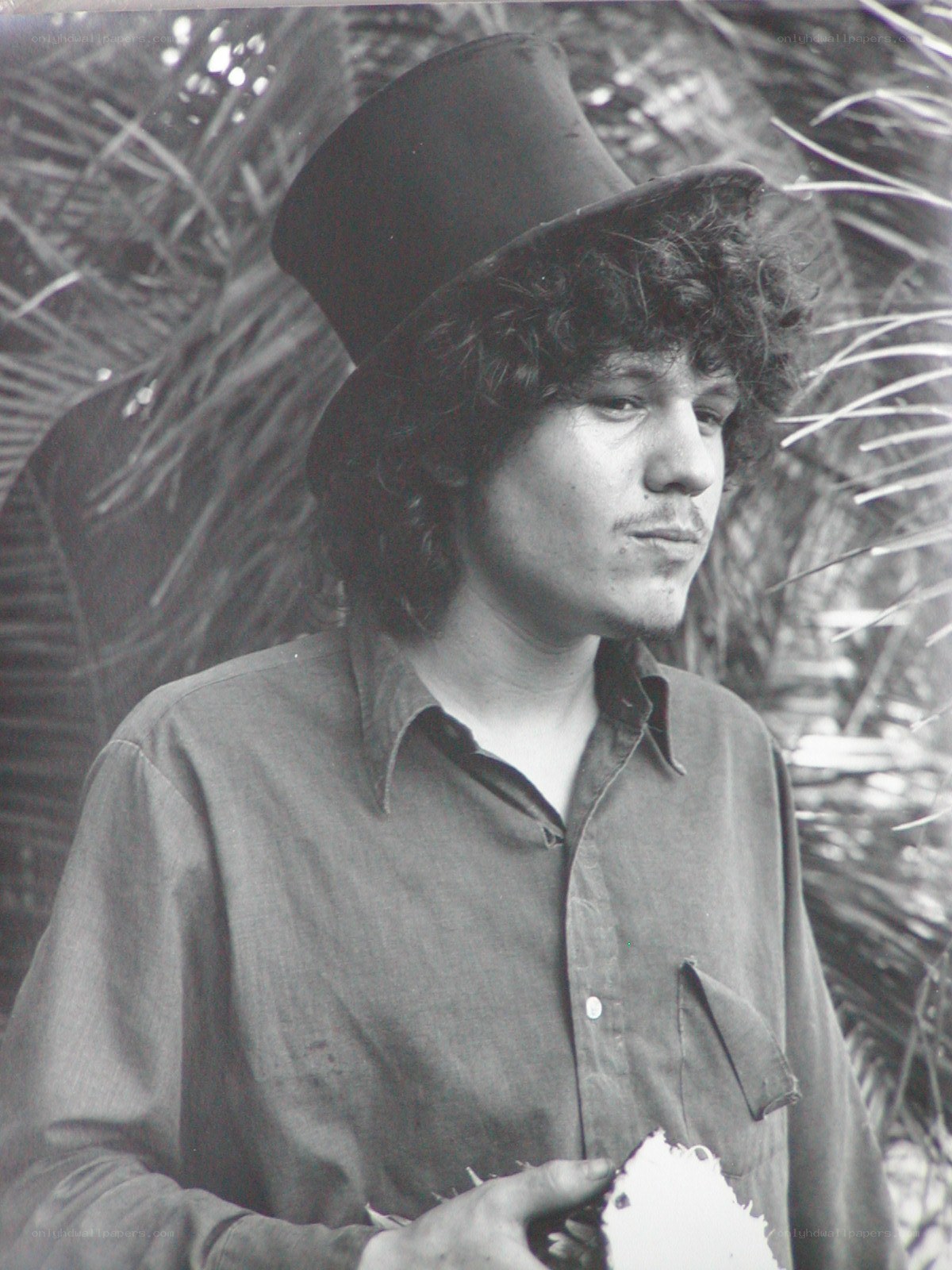 man in top hat holding coconut